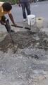 Fig f: Here Gregorio is using the pickax to blend the mixture because its a lot easier to move through the gravel in this way.