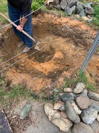 Image 3: After removing the liner, we began to dig out the layer of clay from the previous construction, in order to level the bottom of the pond and make it a bit deeper.