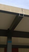 Fig 1a: Close-up of sawed-off gutter cap where water drained into the quad.