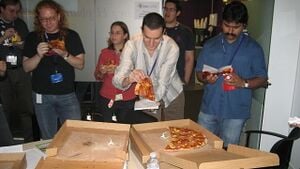 People eating pizza at BarCamp London.jpg