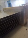 All plates stacked between rubber extrusions. Then with wooden piece screwed on the end to compress.