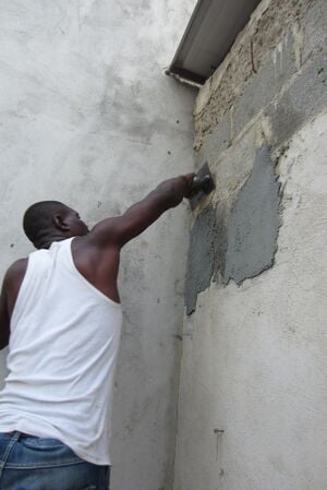 Figure-5: Using the trowel to smooth out plaster.