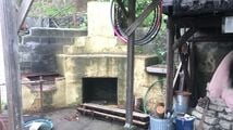 This will be the site of the cobb bench with the back of the bench against the face of bricks. Shown here is the full view of the existing chimney and ancient stove from before CCAT days.