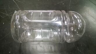 The top and bottom of the bottle are removed, and one cut has been made along the length.