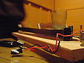 Solder other ends of wires to LED. Attach wires to wood but leave slack for movement