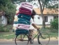 Figure 1: Cyclist carrying mattresses, Puttalam District. An example of ordinary bicycle used to transport difficult loads. Photo: Practical Action.