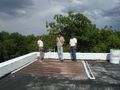 System on roof with Perote staff and Aaron Antrim, student project team member.