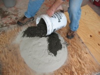 To create the stove’s top clay layer, one bucket of filtered sand, one bucket of mortar, and a half-bucket of mortar clay (2:2:1 ratio) were thoroughly dry-mixed with a shovel on a large sheet of plywood. Tap water was slowly added and mixed in until a sticky and non-runny clay like consistency was reached. The GIRA team indicated that the ideal consistency for the mixture can be described as “chewing gum.”