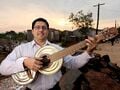 Fig 1: Favio Chavez with handmade recycled guitar