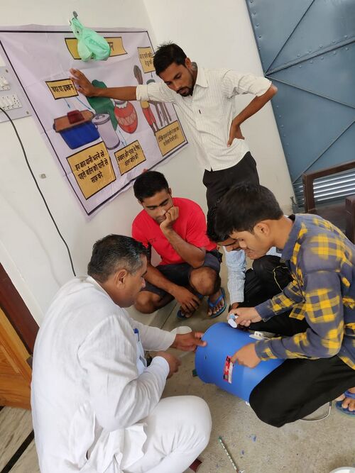 File:TavelaGarhiAdults&KidsWorkOnSafeWaterStorage.jpg