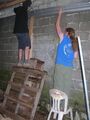 Fig. 3b: Zack and Robert nailing the gutter to the wood beams