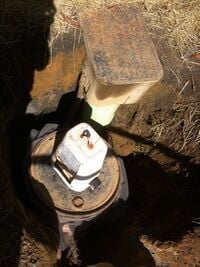 Figure 4 - Top view of surge tank connected to the house plumbing. The filtering mechanism has been pulled out and placed on top. Photo by Ben Stern