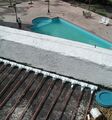 Collector on roof with view of alberca (pool) below.