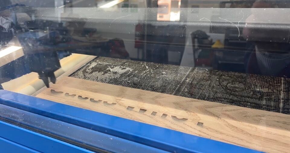 2: All titles and phrases were laser engraved into a thin piece of wood then cut to size and wood glued onto the wood base.