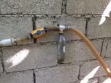 The methane travels past a drip container into a storage container.