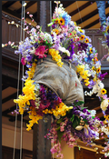 Although this is a floral arrangement, if the pant legs are sewn up, you can add soil and plants and hang on a wall