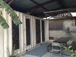 This shipping container has been made into an office area. Large sections of the wall were cut out and replaced with artful metal windows for increased ventilation.