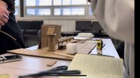 Image of a scale cardboard model of the entire system on location.