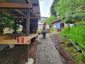 Maddy demostrating the width of the path way, wide enough for wheelbarrow access