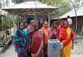 Bangladeshi Women stand behind a completed OHorizons concrete BioSand Filter.