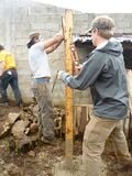 The posts are placed in the holes and checked to be level.
