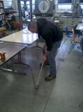 Using a conduit bender to bend conduit.