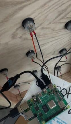 6: Wiring connecting the buttons to the Raspberry Pi, which is then connected to the screen and speaker. All receiving power from an outlet.