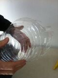 Cut strips all around the bottle.