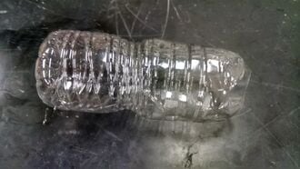 Cut the top of the bottle off.