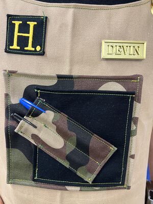 'Hand-sleeve' with multi-purpose black pocket and angled camo pencil pockets