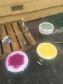 Using stencils to spray paint designs on buckets