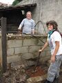 Compacting bricks for base of waste chute.