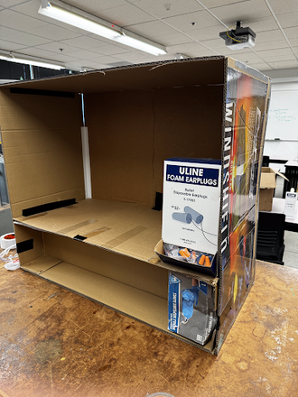 Prototype 1 - Cardboard cabinet with glove box section and ear plugs.