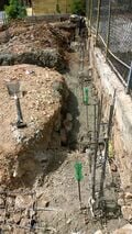 Concrete being poured intro trenches onto rebar.