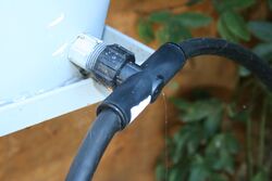 Figure 3: The T-fitting located at the storage bucket outlet splits the main water line to allow watering of multiple beds.[1]