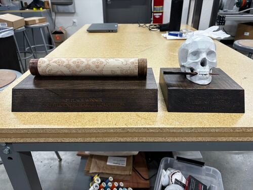 Final iterations of Skull and Scroll trophies for the Humanities and Letters category.