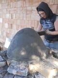 Fig.12 The sand dome is almost done. Jodi is compressing the sand by "tamping" it