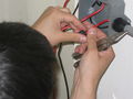 Garrett attaching the industrial rectifier diode to the junction box, complete with heat-shrink tubing.