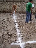 Fig: Lime is poured over the string to mark where to dig.