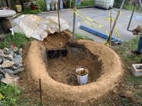 Image 4: Nearly finished berm with clay slurry layer applied.