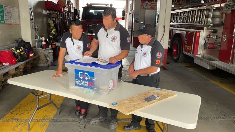 File:Firefighters building the Simple version of the CrashSavers DIY Tourniquet Simulator.jpg