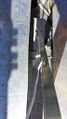 Motor threaded rod assembly. Looking down. Left is the back side of the metal box. This shows the bearing which upon which the aluminum C channel rides. The black item on the right is the limit switch.