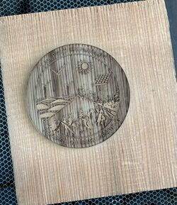The same area on the scrap wood as the previous coaster, after having the laser cutter make the design in the same spot a second time.