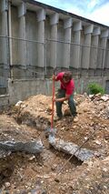 Large cement slab being chipped away.