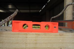 Figure-1: Leveling wall using wood and a level tool.